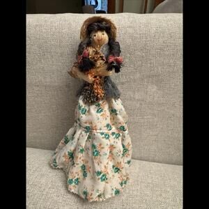 Straw Doll Holding Bouquet